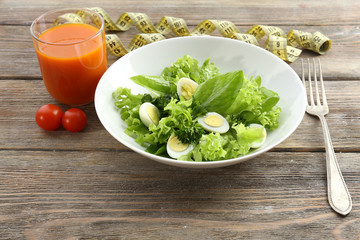 Salad with quail egg and basil in plate