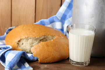 Retro can for milk with fresh bread and glass of milk
