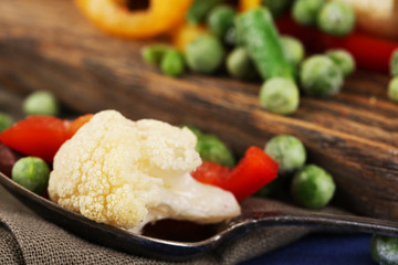 Frozen vegetables on cutting board, close-up