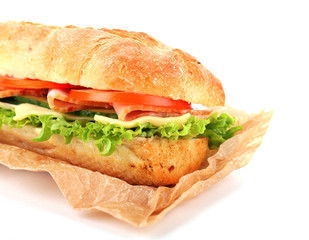Fresh sandwich on parchment isolated on white