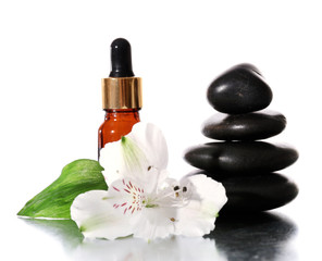 Spa stones with aromatic oils and flower isolated on white