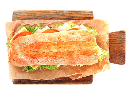 Fresh Sandwich On Wooden Cutting Board Isolated On White