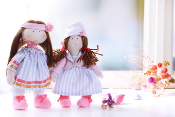 Handmade doll near window close-up