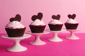 Delicious Valentine Day cupcakes on pink background