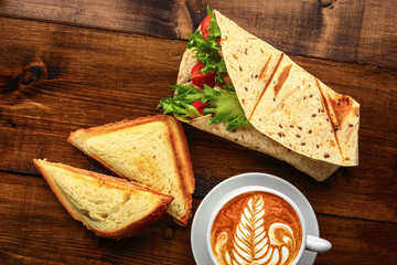 Breakfast with cappuccino and sandwich