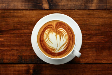 cup of cappuccino on a wooden table