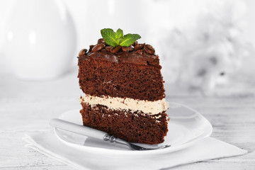 Delicious chocolate cake on table on light background