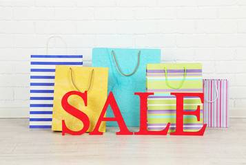 Sale with bags on floor on bright background