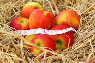 measure tape and red apple