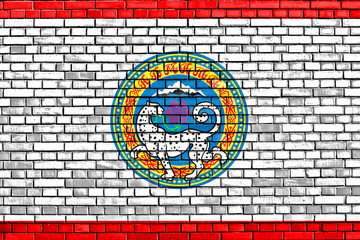 flag of Almaty painted on brick wall