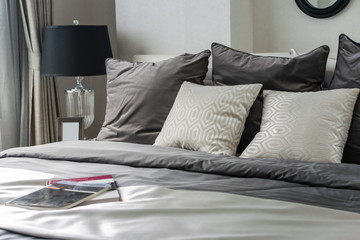 white and grey pillow on bed