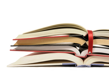 Untidy stack or pile of open books isolated white background photo