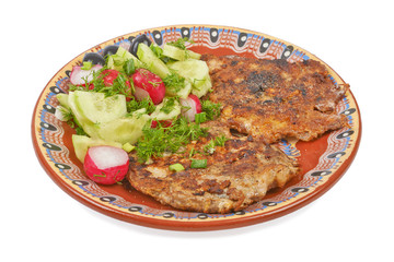 Portion of meat fried with a salad of radish and cucumber isolat
