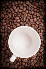 Empty coffee cup and coffee beans