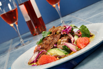 Barbecued steak salad and glasses of wine