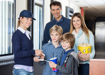 Happy Family Getting Tickets Checked By Worker At Cinema © Tyler Olson