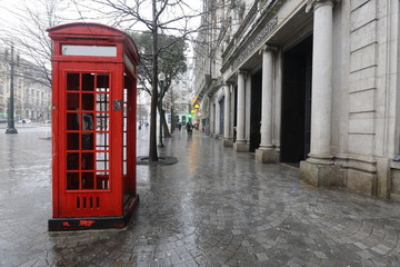 Red telephone booth in the rain © AnastasiiaUsoltceva