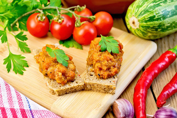 Sandwich with caviar squash and red pepper on board