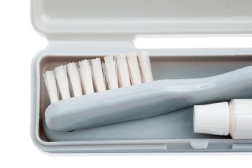 cropped shot of toothbrush and toothpaste in case