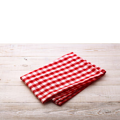 Top view of checkered tablecloth on white wooden table.