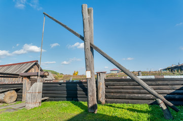 Old wooden water crane well in village