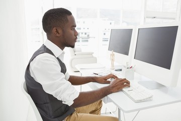 Fototapeta na wymiar Classy businessman concentrating and using computer