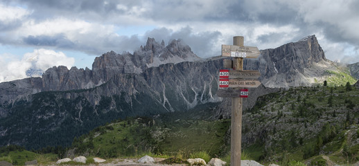 Wooden trail signs with Lastoi de Formin mount, Dolomites