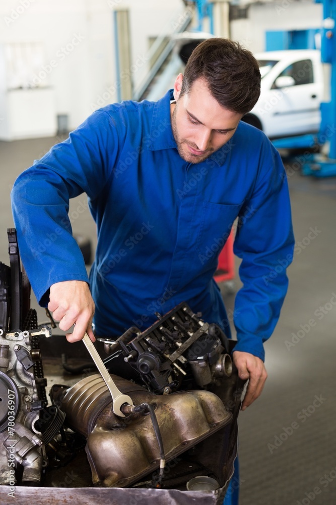 Poster mechanic working on an engine