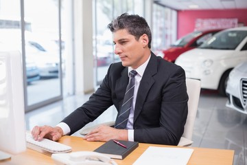 Focused businessman using his laptop