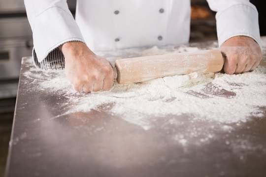Close up of baker using a rolling pin