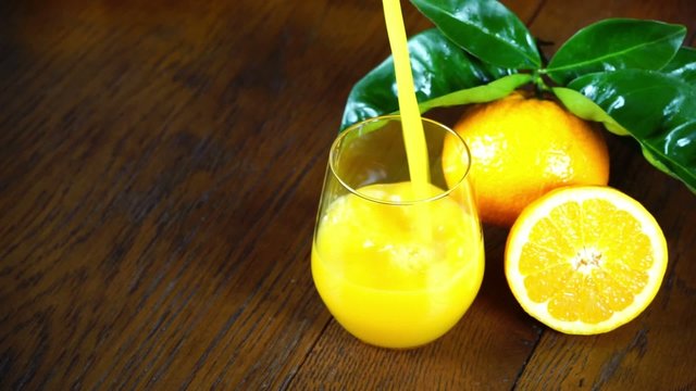 fresh orange juice pour in a glass
