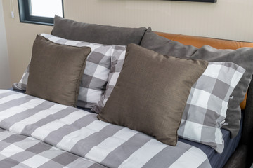 bed and brown pillows in modern bedroom