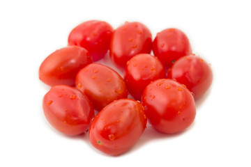 Closeup of several ripe plum tomatoes, isolated on white