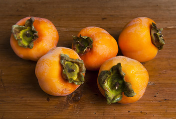 Fresh ripe persimmon on a wooden table