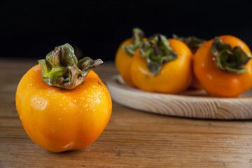 Fresh ripe persimmon on a wooden table