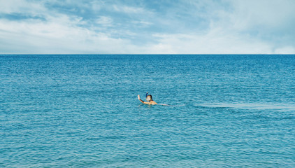 Girl snorkeling in mask in the sea