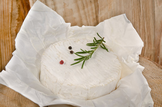 camembert with wooden background