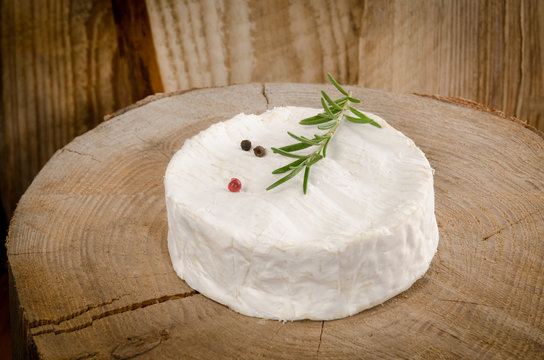 camembert with wooden background