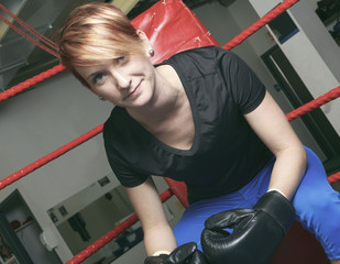 fitness woman doing punching exercises in training place