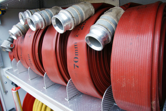 fire hoses rolled up in fire engine locker