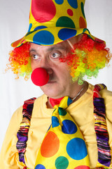 Clown holding and juggling against a white background.