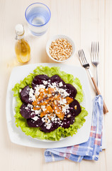 vegetarian salad with beet and roasted pumpkin. served with pine