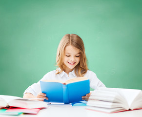 happy student girl reading book at school