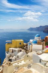 Churches of Oia village under puffy clouds, Santorini
