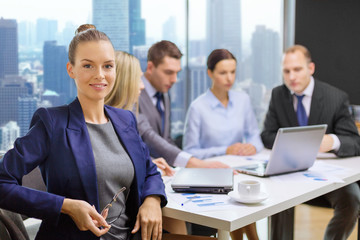 businesswoman over business team in office