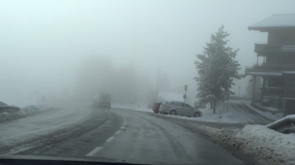 Heavy fog on a country road, car point of view