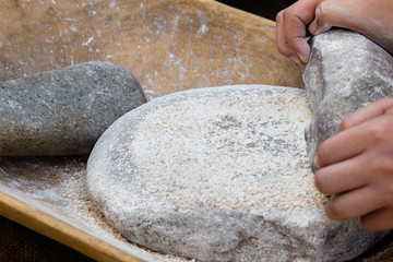 Making flour in a traditional way for the Neolithic era