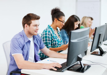 student with computer studying at school