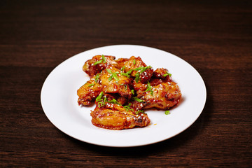 Chicken wings on white dish