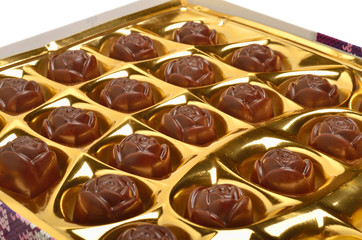 Chocolate sweets in the box on white background